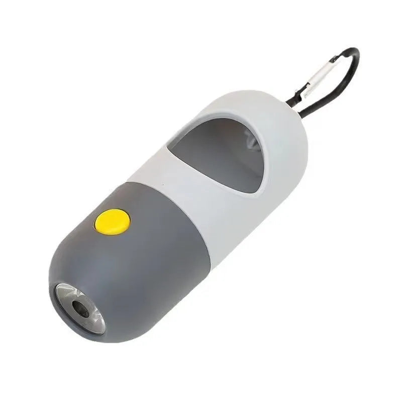 A white and gray capsule dog waste bag dispenser with a black handle and LED flashlight.