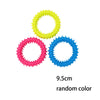 Three bone-shaped rubber chew toys in yellow, pink, and blue.