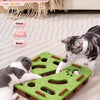 A tabby cat interacts with a green felt puzzle toy designed for cats.