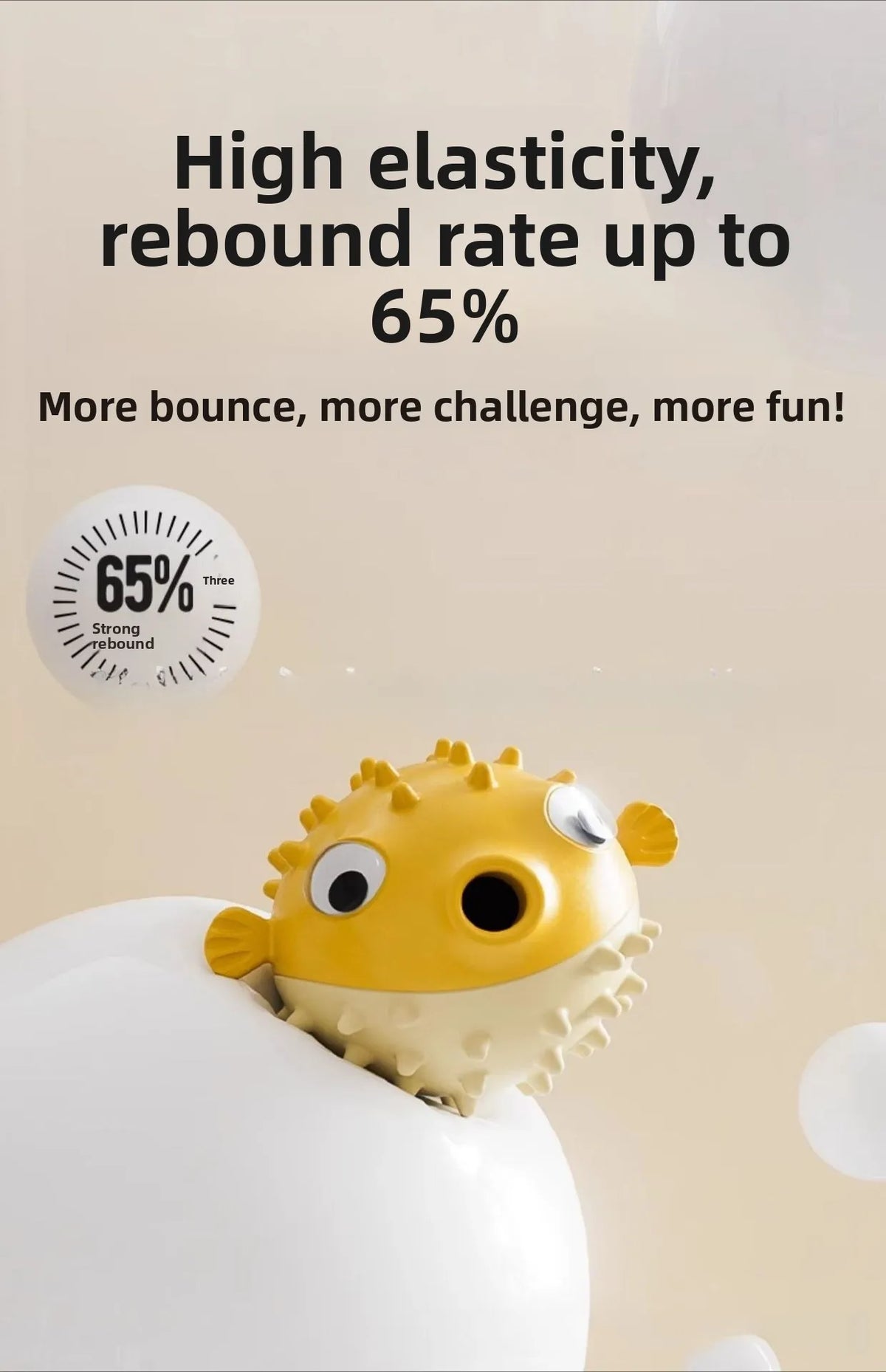 A yellow, textured fish-shaped bouncy toy is shown resting on a white surface.