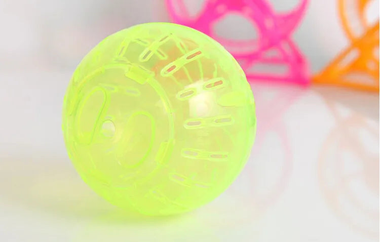 A transparent lime green hamster exercise ball resting on a white surface.
