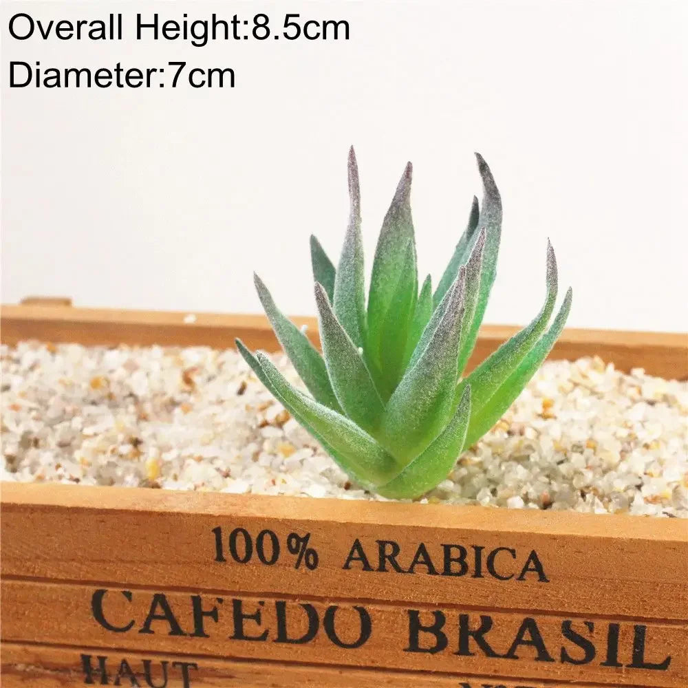 A green flocked artificial succulent plant in a wooden box with light gravel surrounding its base.