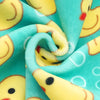 Fabric pattern featuring yellow duck faces on a teal background