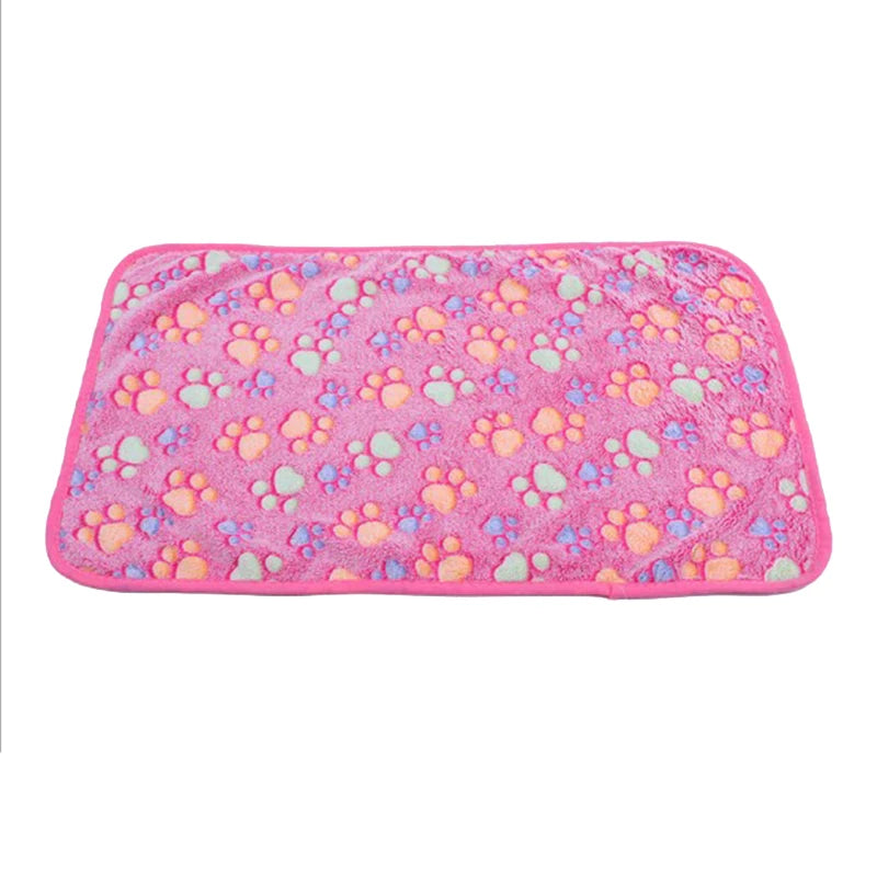 Pink flannel fleece pet blanket with a paw print design.