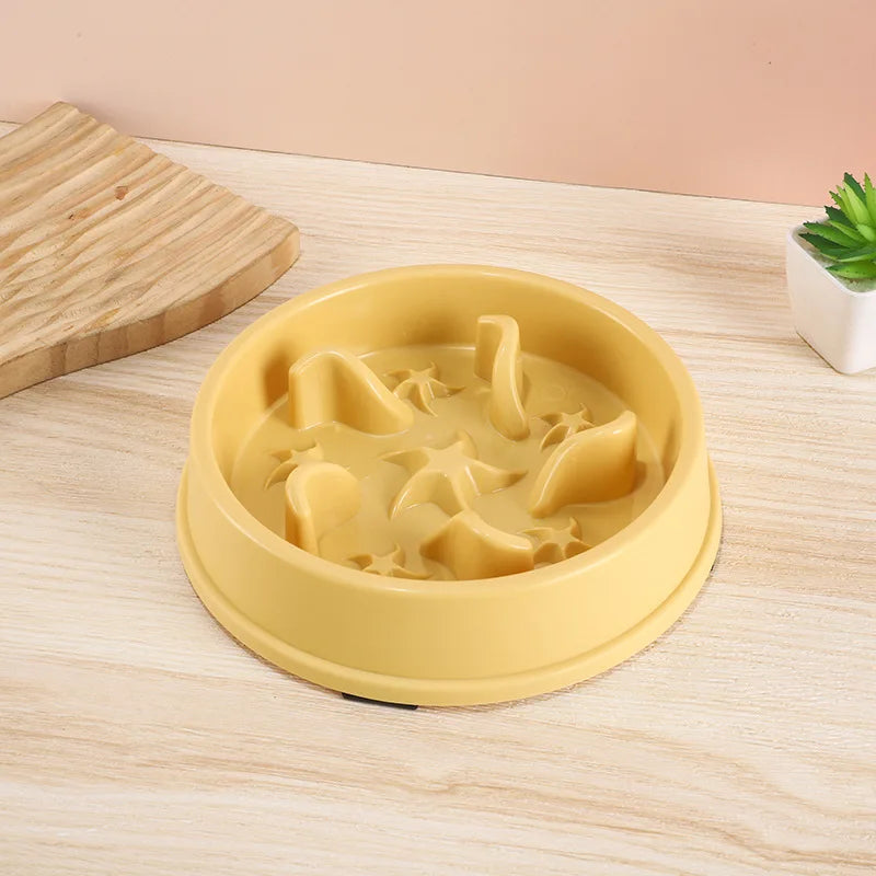 A yellow anti-slip slow feeder bowl filled with wet food for small dogs and cats on a wooden surface.