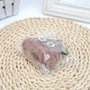 A brown silicone dog waste bag dispenser is visible on a woven mat.