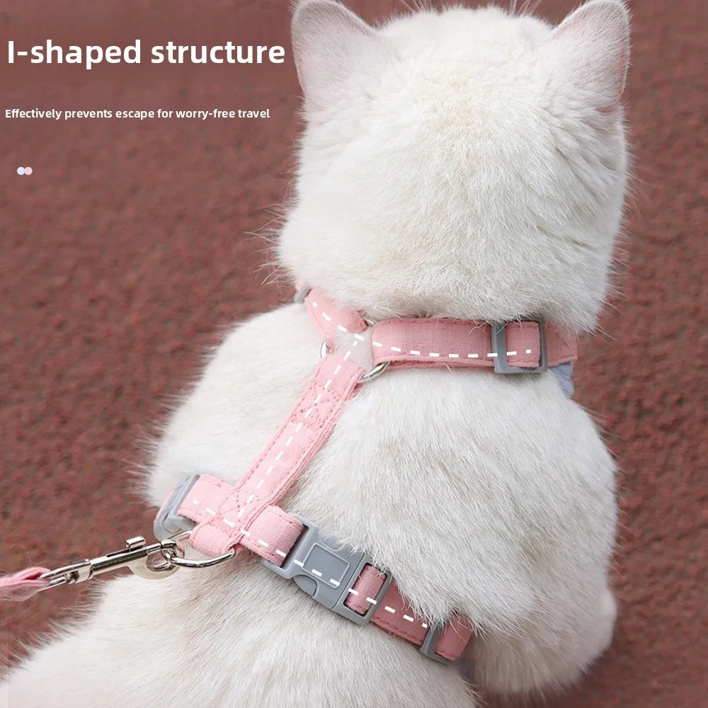 A white cat wearing a pink and gray I-shaped harness and leash set for worry-free travel.