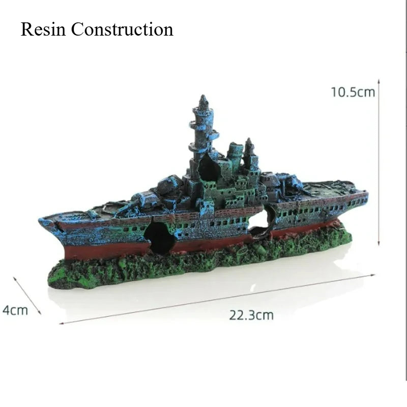 A resin construction model of a sunken ship with a cave hideout, featuring red and blue colors on a green base.