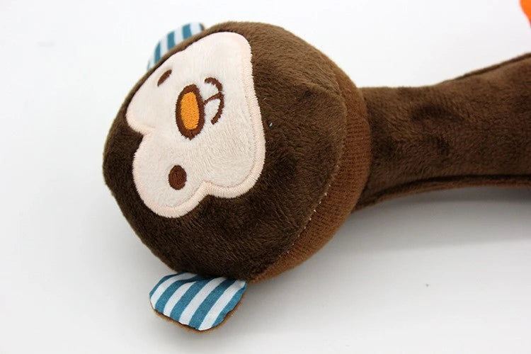 A brown plush dog toy with a light-colored face design and striped fabric accents.