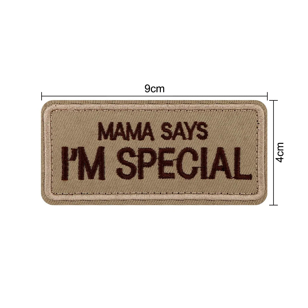 A tan embroidered patch with the text Mama Says I'm Special on a fabric background.