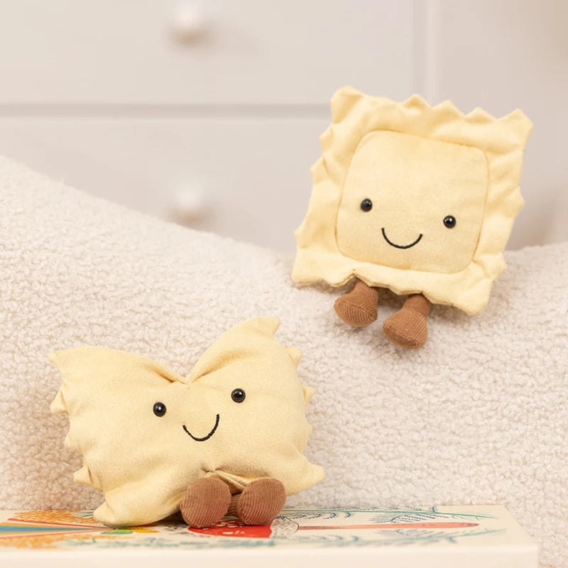 Two cute, light yellow plush toys shaped like desserts are resting on a white surface.