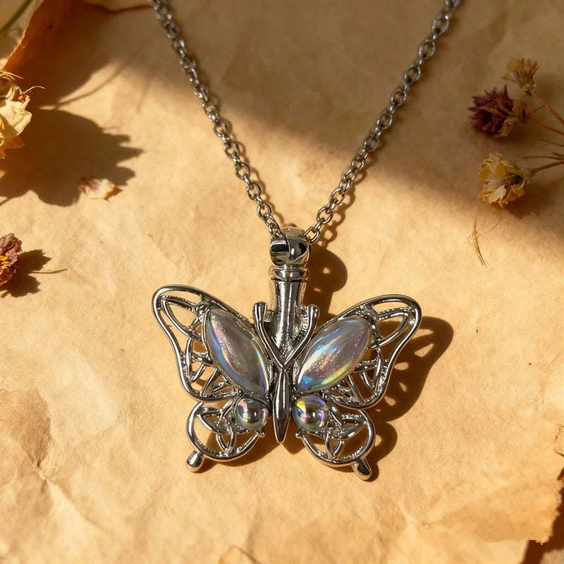 Silver butterfly ashes urn necklace hanging against a light brown paper background