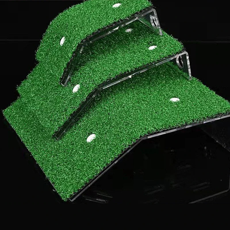 A green grass ramp platform with suction cups is shown against a black background.