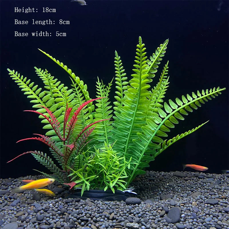 A vibrant artificial aquarium plant featuring green and red foliage planted in dark gravel.