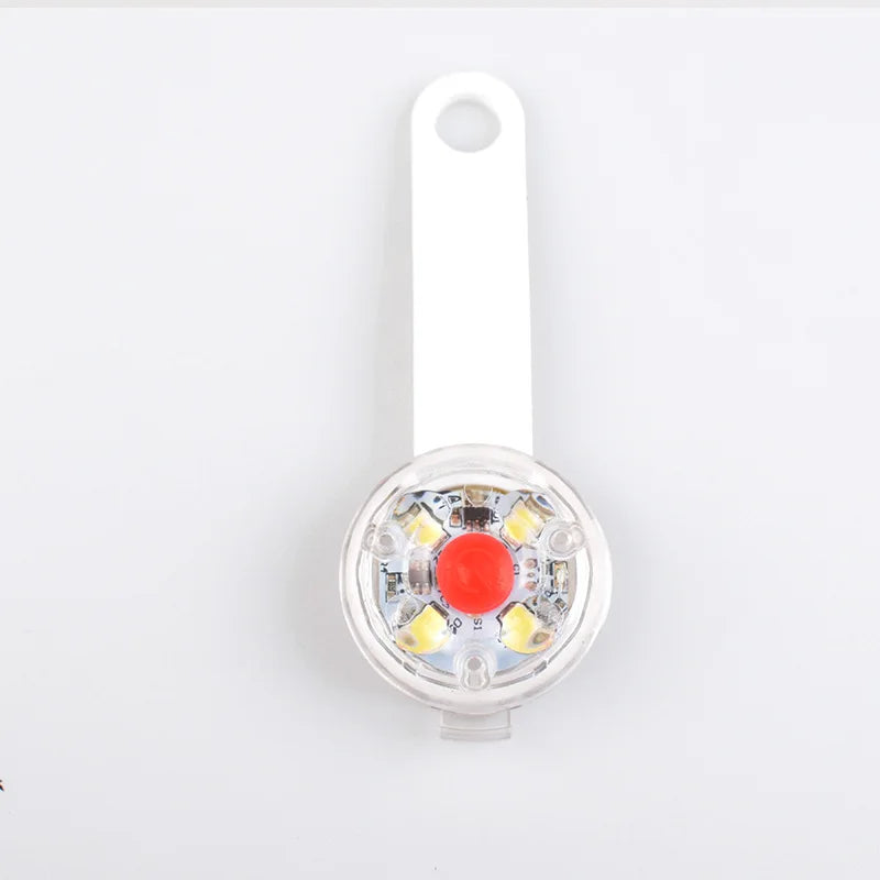 A clear LED dog collar light with a white clip and a red lens is shown.