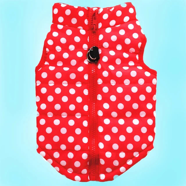 A red polka-dot dog coat with a zipper and a black snap closure.