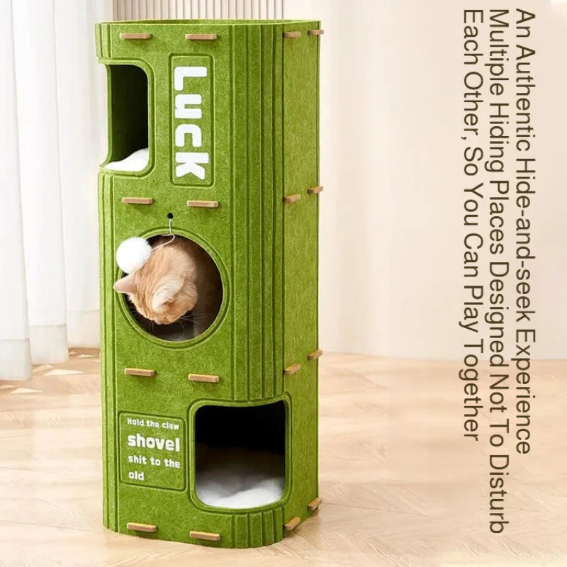 A vertical green cat house with a slot for a claw and a hole for a chew toy