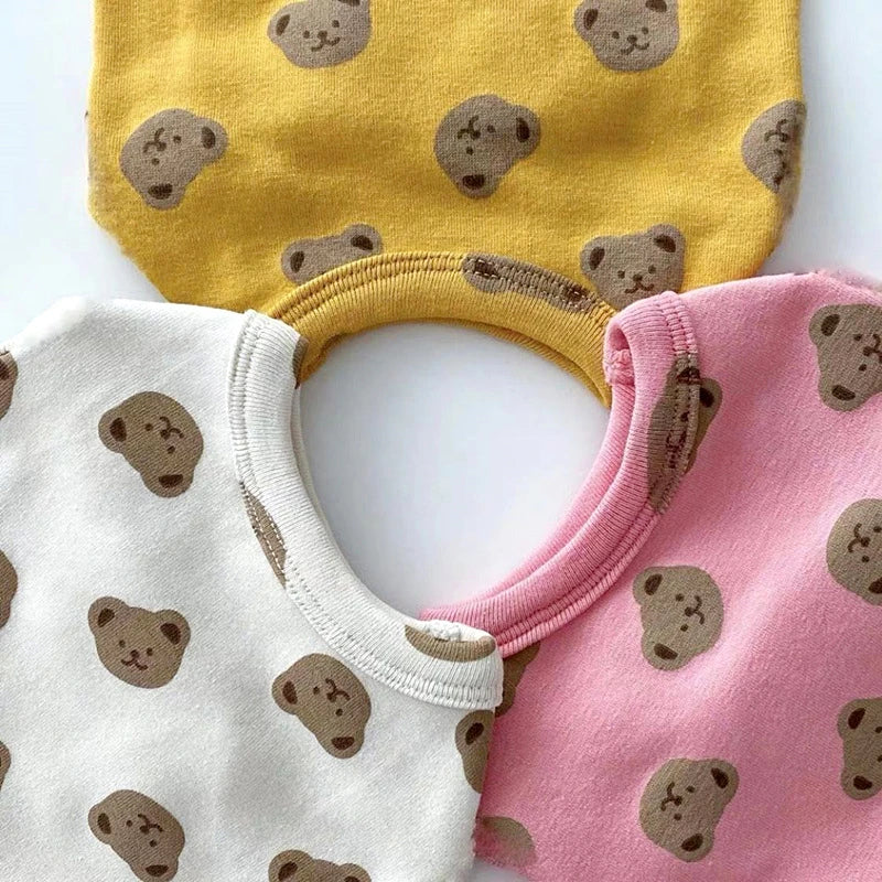A set of yellow and pink cartoon print pet vests for dogs.