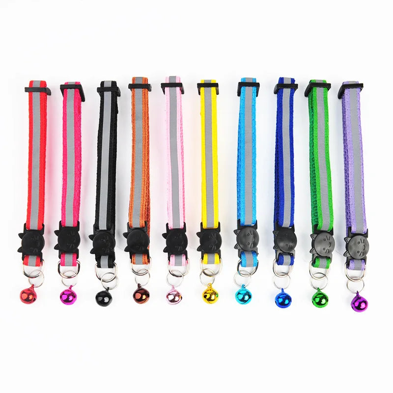 A row of colorful reflective pet collars with bells, featuring various nylon safety colors and adjustable clasps.