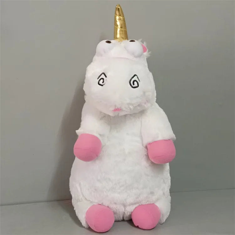 A white unicorn plush doll with a gold horn and pink accents, sitting upright.