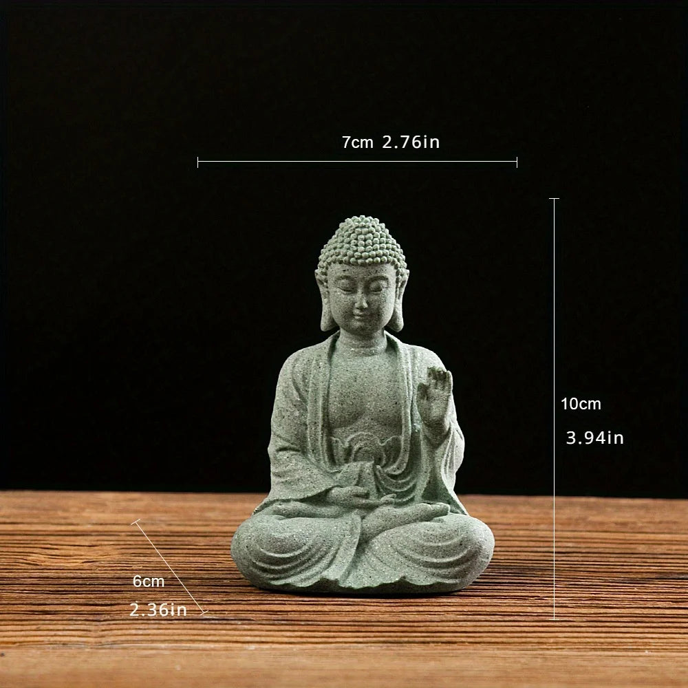 A small, seated Buddha stone statue with a serene expression, used for meditation or decor.