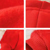 Close-up view of a bright red plush winter hoodie fabric showing texture and stitching.
