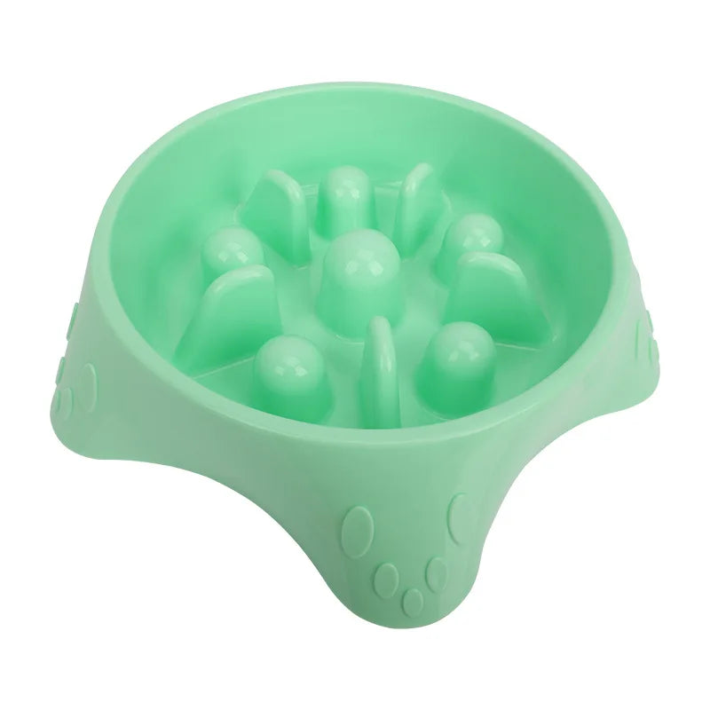 A light green slow feeder dog bowl with raised silicone puzzle features for feeding.