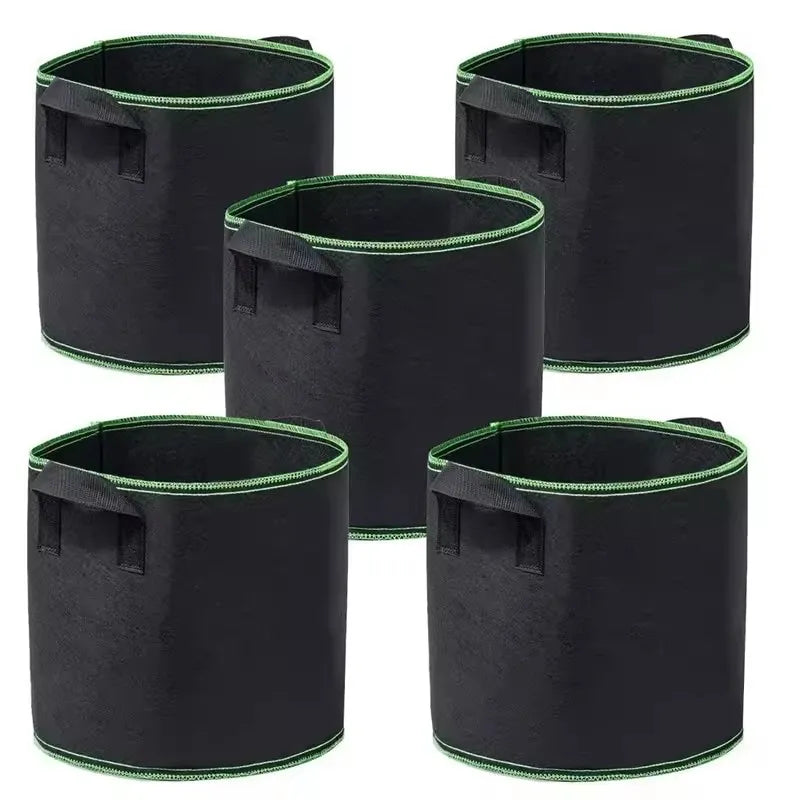 Four black non-woven aeration grow bags with handles for plants and flowers