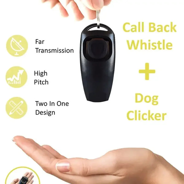 A hand holds a black dog training whistle and clicker combo device.