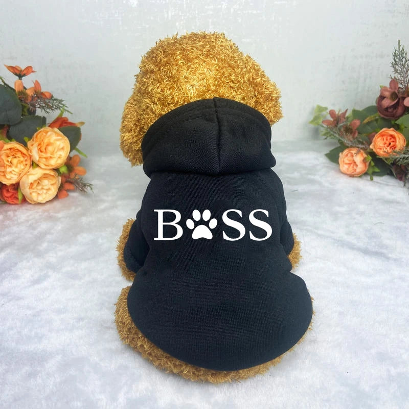 A black fleece hoodie with a tan fur hood and white text reading BOSS on the back.