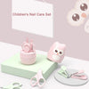 A pink children's nail care set featuring various tools like clippers and files displayed on a light green surface.