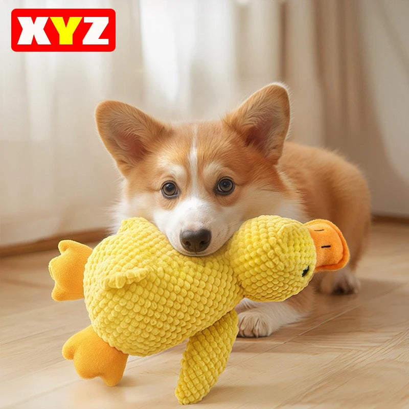 A fluffy yellow plush duck toy dog is being held by a small dog.