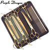 A black case containing a pair of gold-toned professional stainless steel pet grooming scissors and a comb.