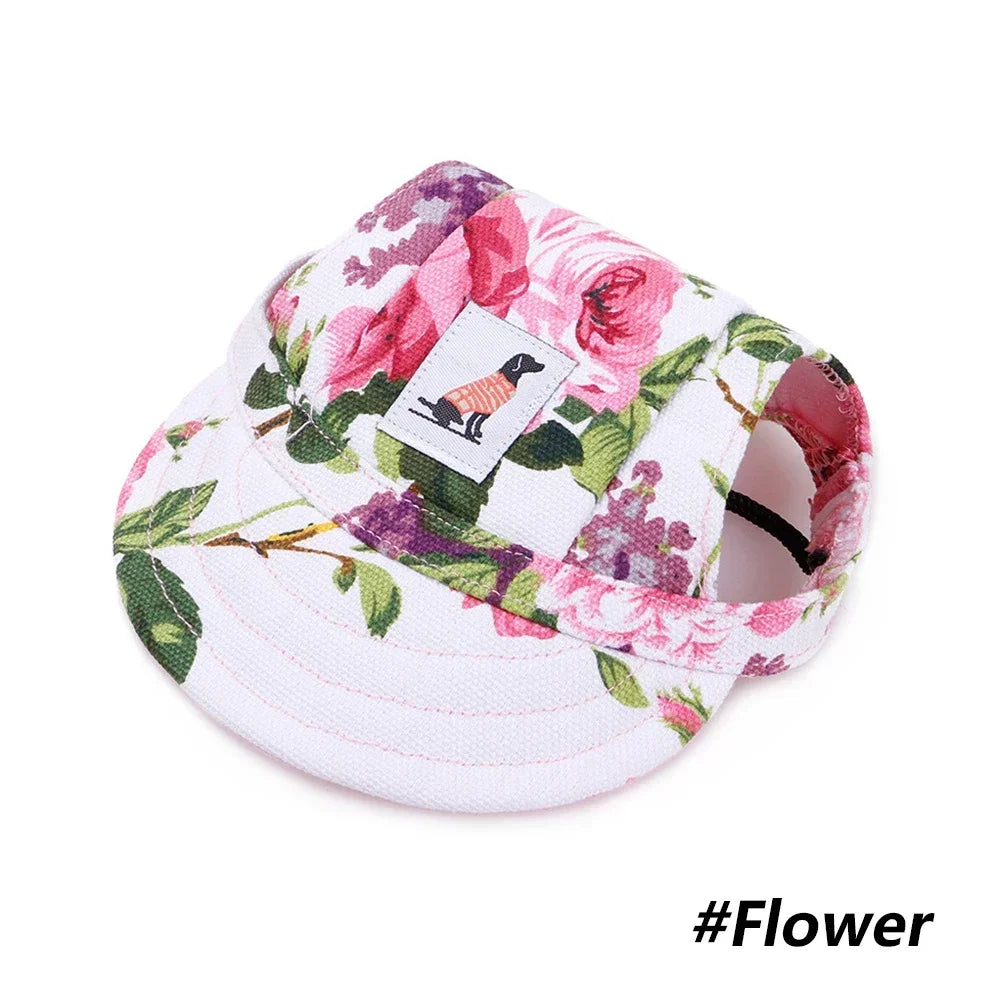 A pink floral print visor cap featuring a silhouette of a dog on the front.