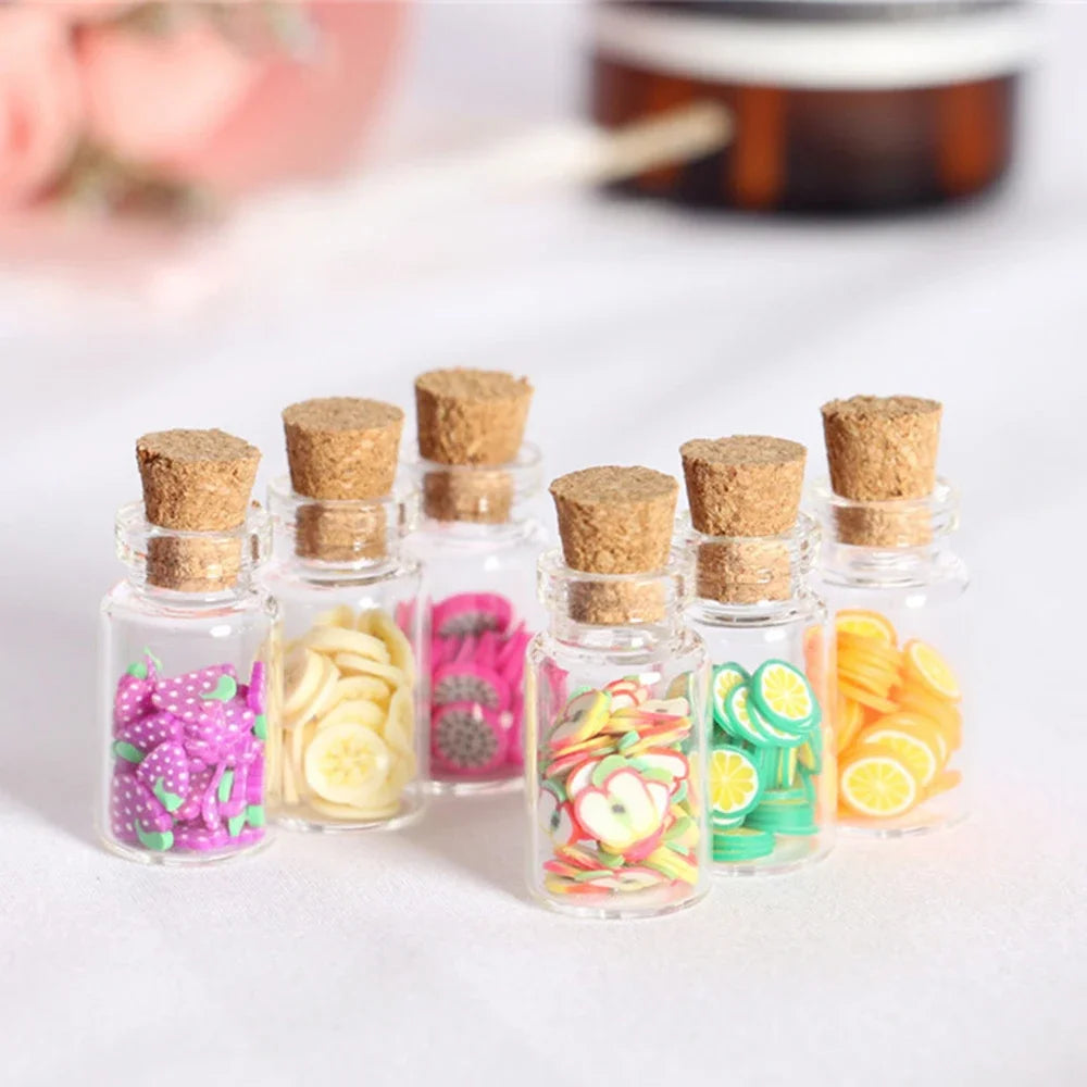 A collection of ten mini glass bottles filled with colorful dried fruit and herbs, sealed with natural cork stoppers.