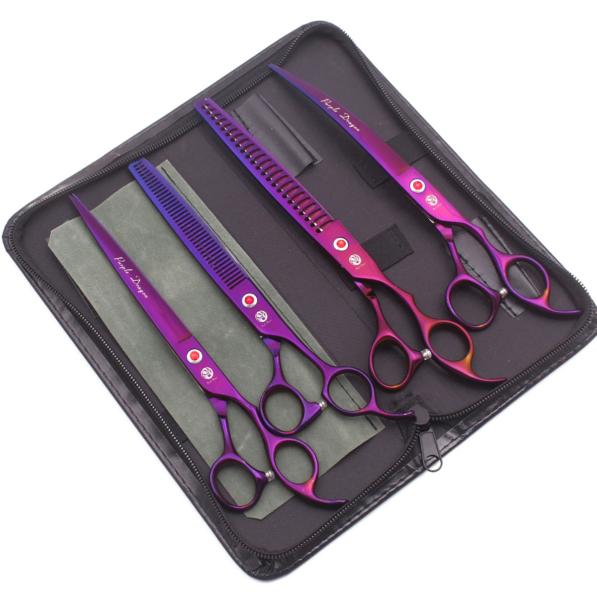A set of professional stainless steel pet grooming scissors in purple and pink housed in a dark zippered case.
