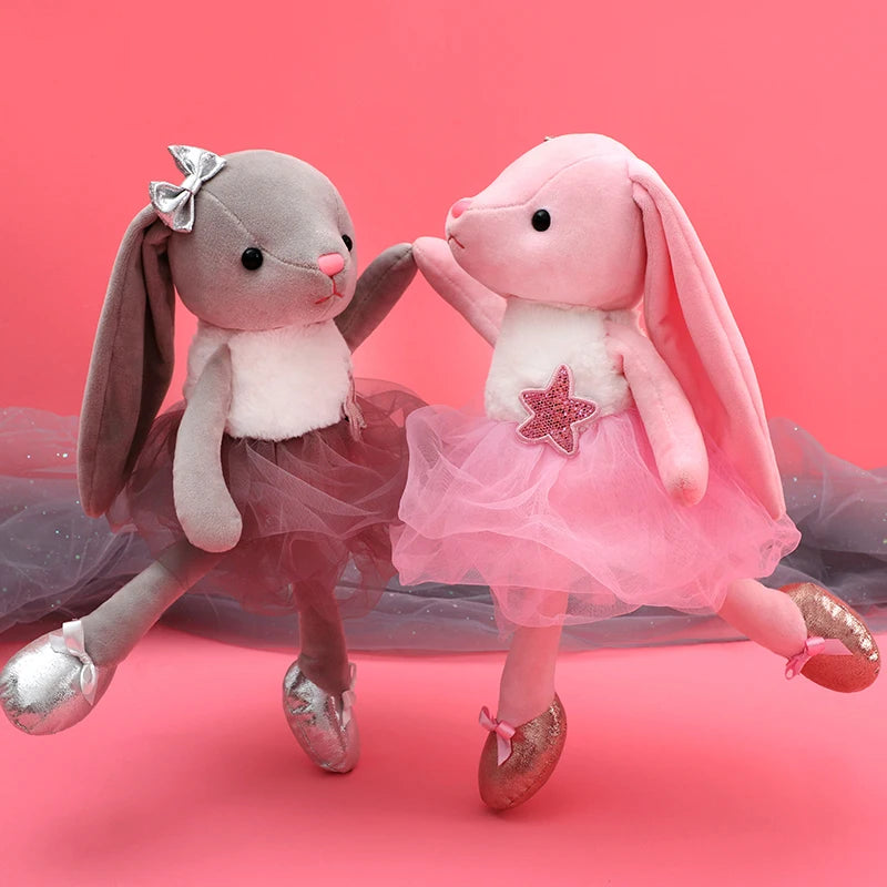 A soft gray and pink plush rabbit stuffed animal toy with a sparkly tutu and glittery shoes.