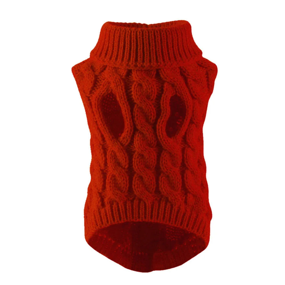 Pull en tricot orange avec poignet côtelé et corps texturé, ressemblant à une forme de chiot.