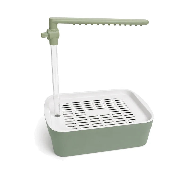 A light green bird bath with an adjustable spray wand and a rectangular tray for water.