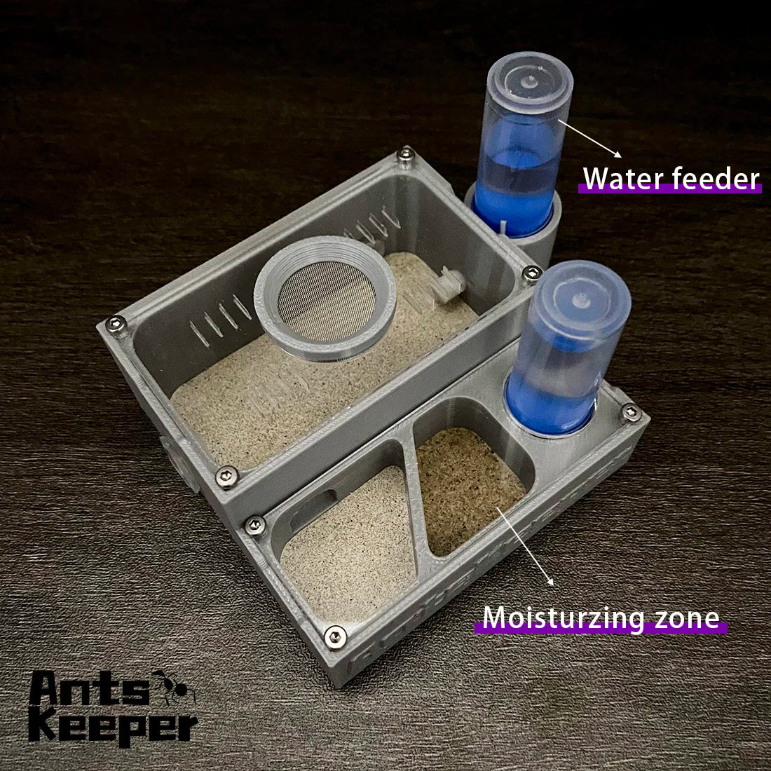 A compact ant farm kit showing a moisturing zone and a water feeder setup.