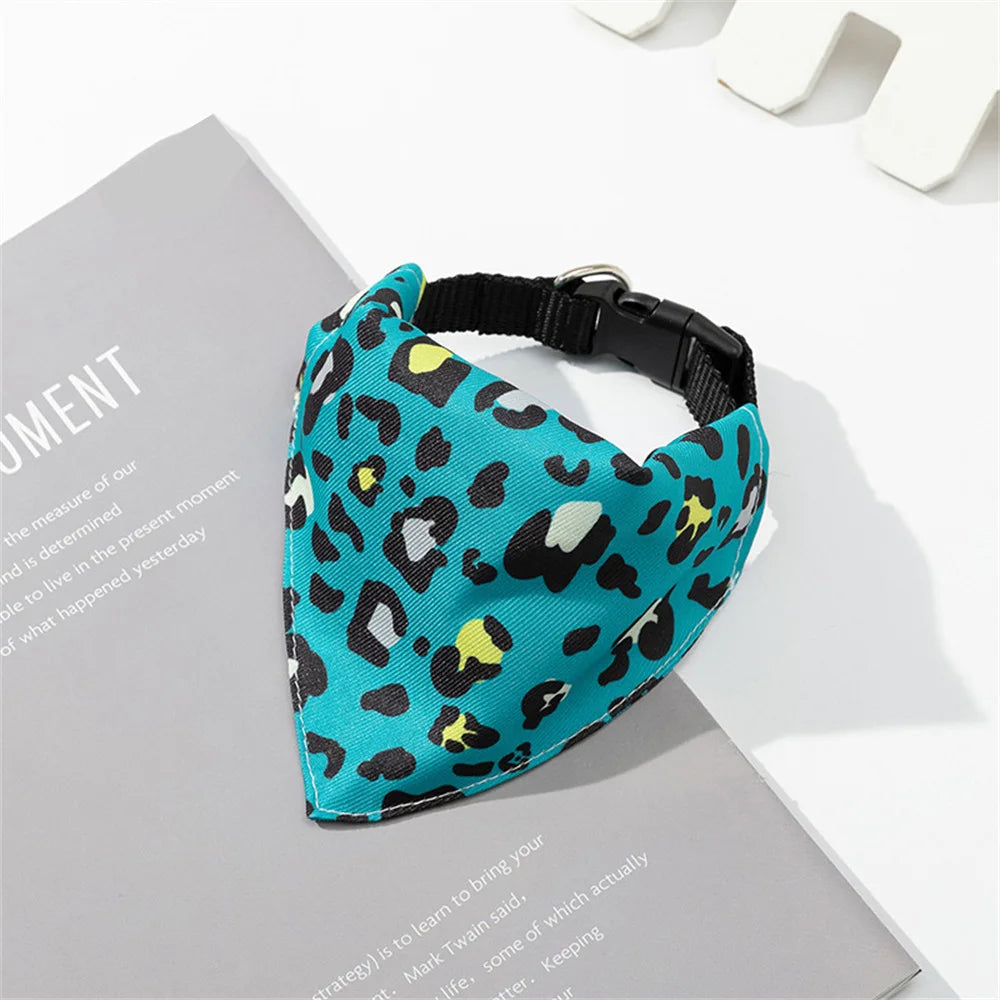 A teal leopard print pet collar with a matching bandana is displayed on a gray background.