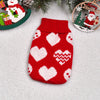 A knitted red sweater with white heart and geometric patterns, displayed on a white background.