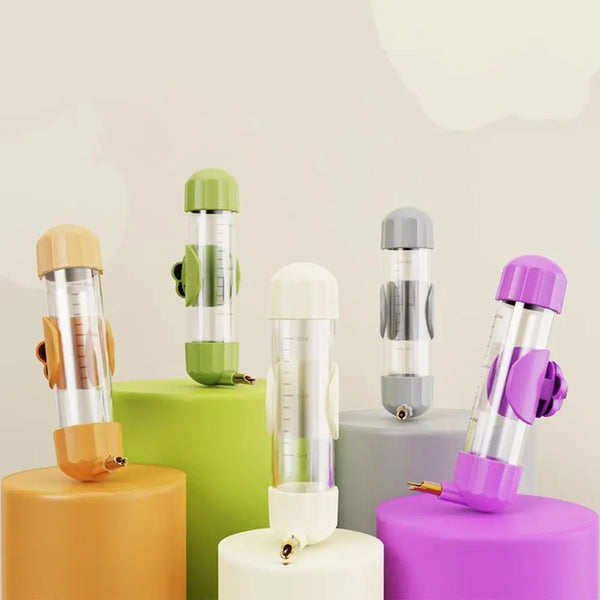 A collection of automatic bird water feeders in various colors including orange, green, silver, and purple.