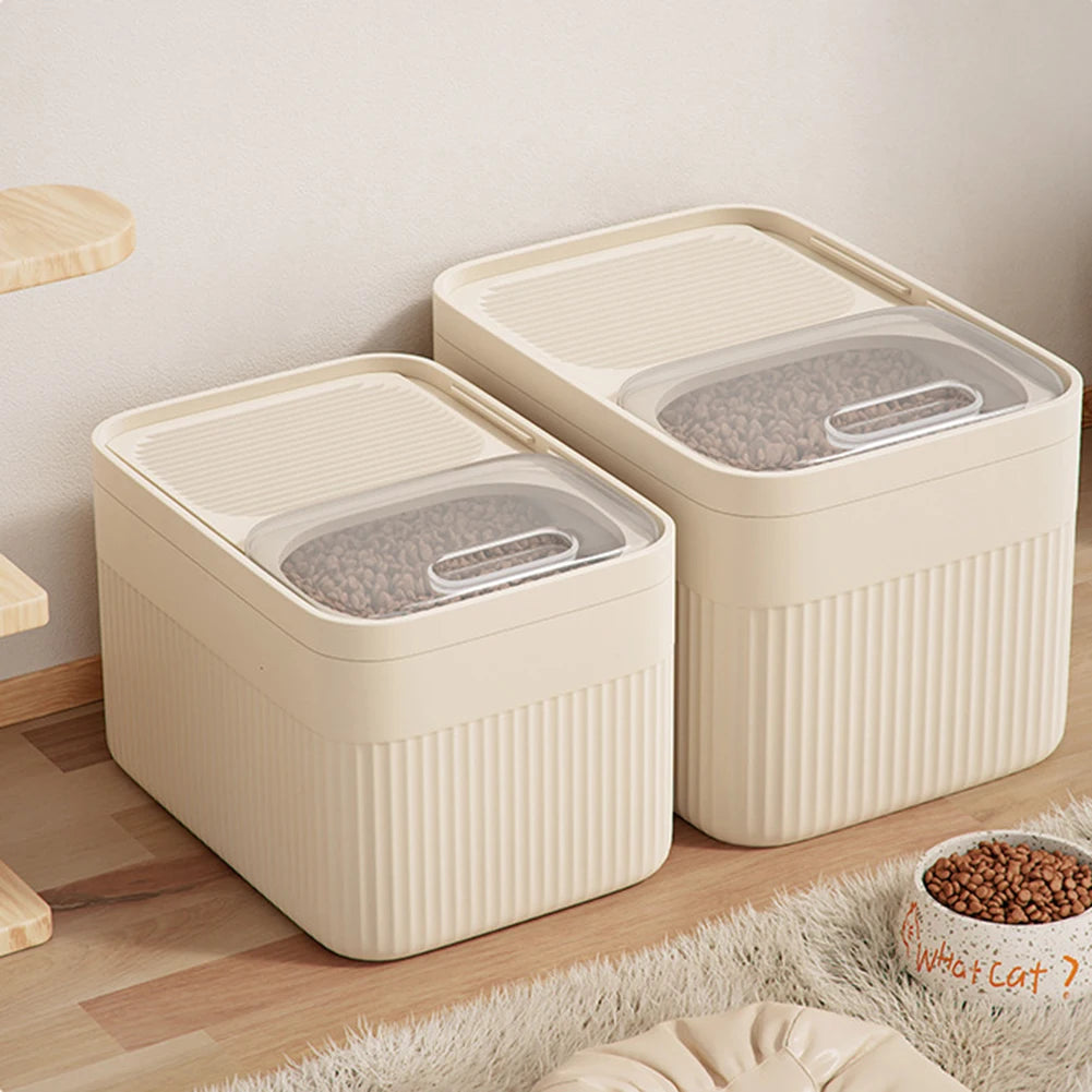 A beige airtight pet food storage container with a clear lid is shown on a wooden floor.