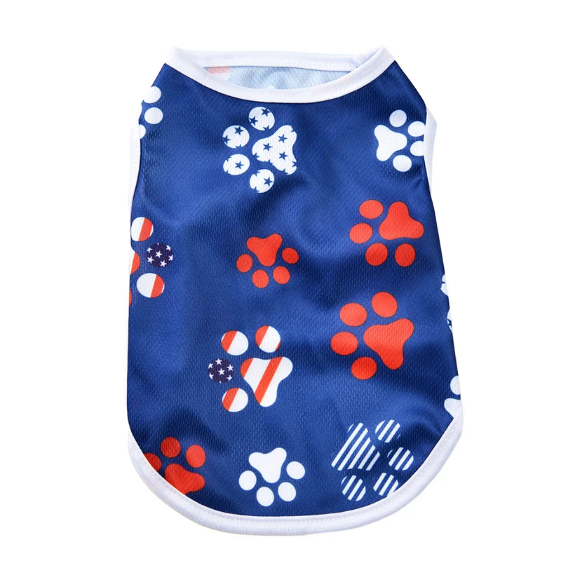 Blue pet vest with white paw prints and red paw prints, featuring an American flag design.