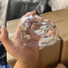 Eine Hand hält ein durchsichtiges Silikon-Tierhaarkeychainset für Paare vor einem Kartonhintergrund.