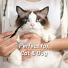 A fluffy brown and white cat is being gently held by a person, demonstrating the Pet Tear Stain Remover Brush for Dogs and Ca