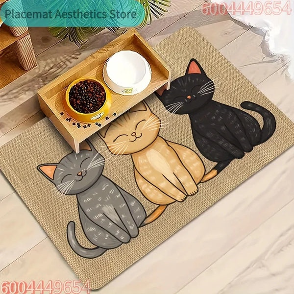 A woven mat features a watercolor illustration of three cats in shades of gray, black, and beige, with a wooden bowl and whit
