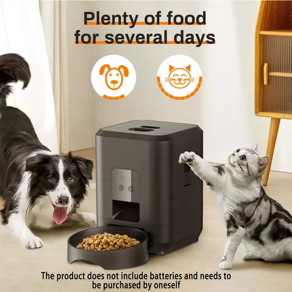 A black automatic pet feeder is shown next to a dog and a cat in a living room setting.