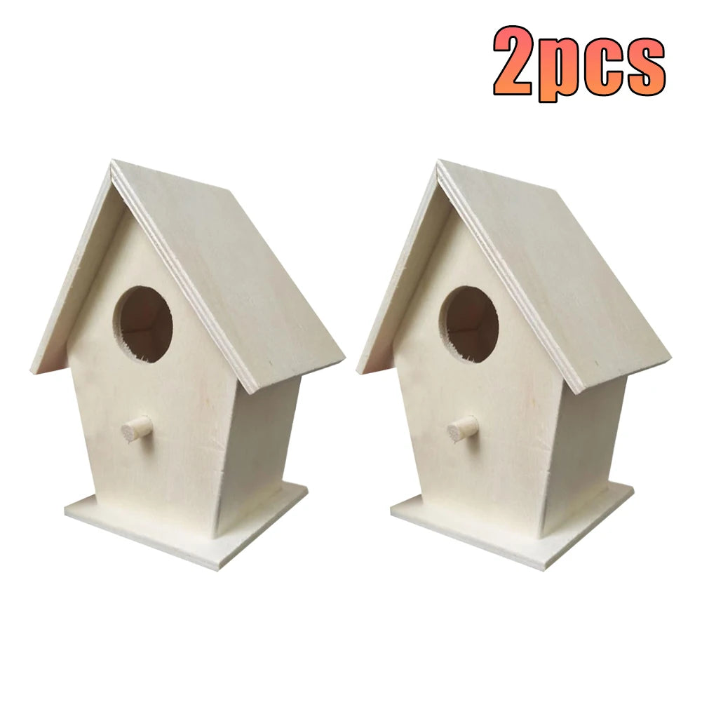 Two white wooden wall-mounted bird houses with pitched roofs